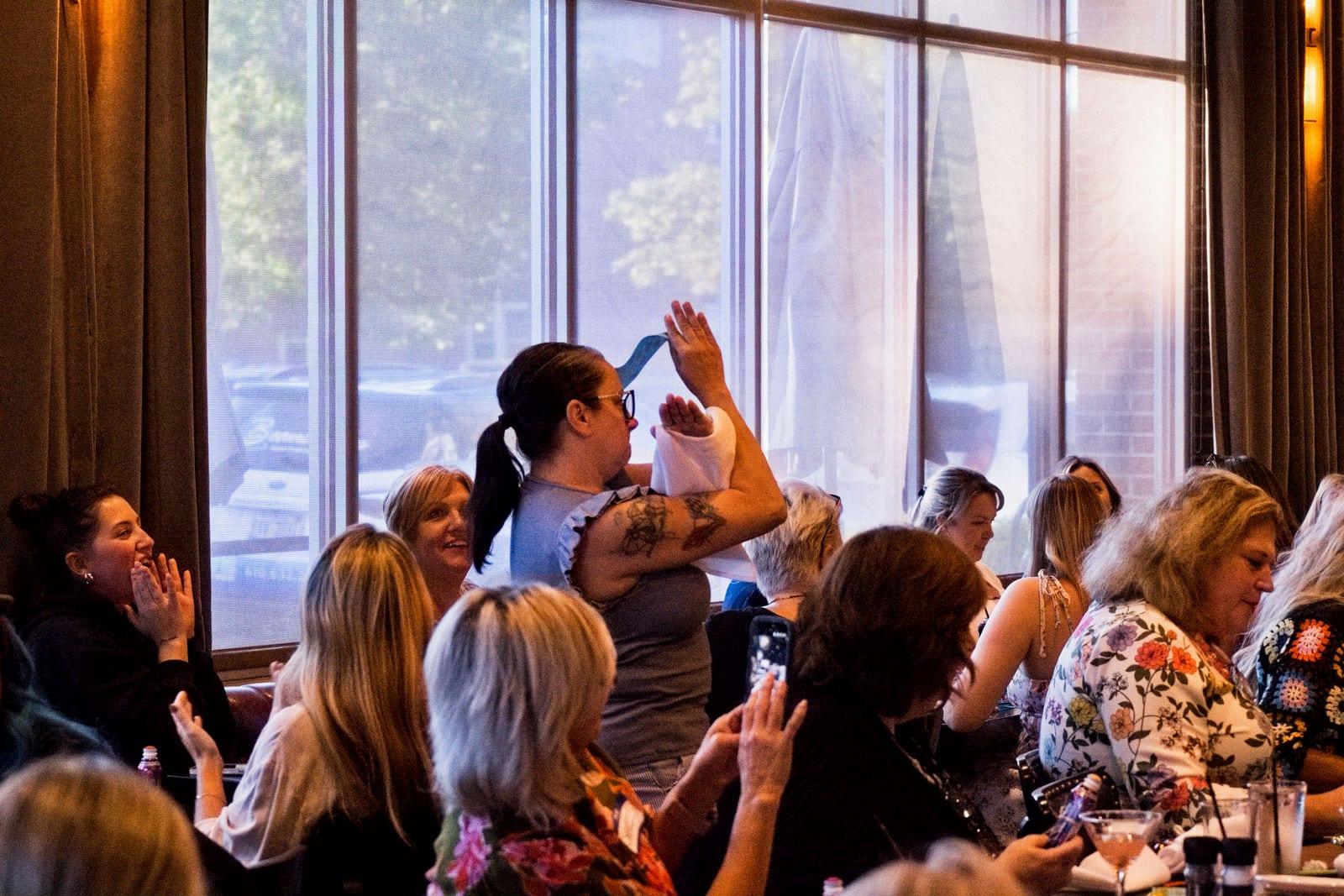 Women cheering as a bingo is called at Lucky Ladies